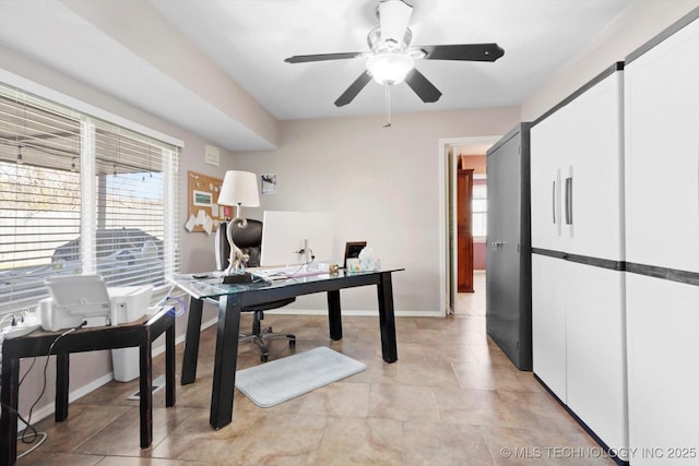 office area featuring light tile patterned floors, baseboards, and a ceiling fan
