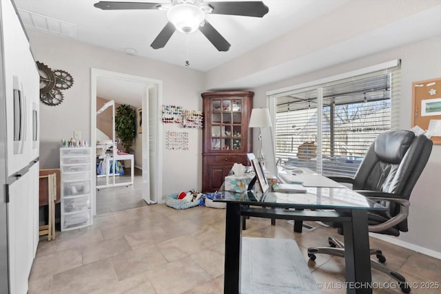 office with ceiling fan and baseboards