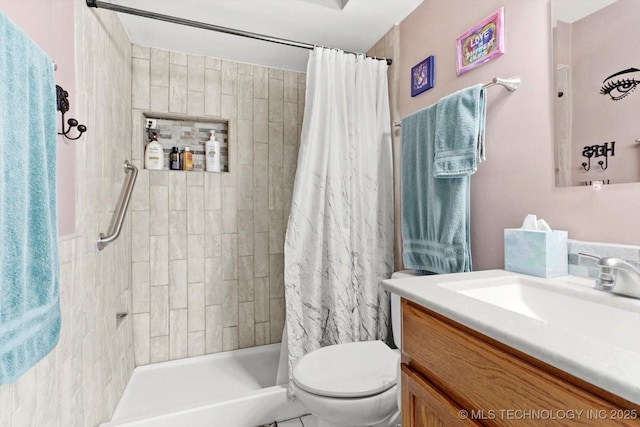 bathroom featuring vanity, a tile shower, and toilet