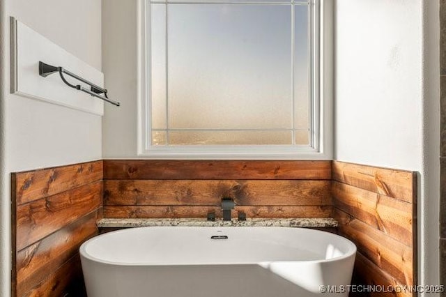 bathroom featuring a soaking tub