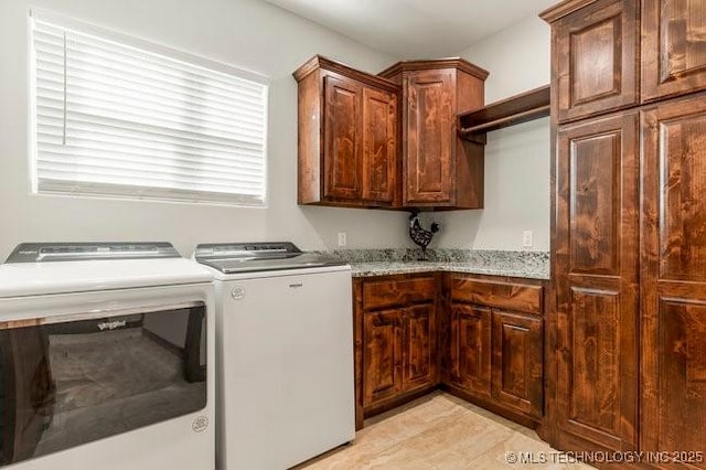 washroom with cabinet space and washer and dryer