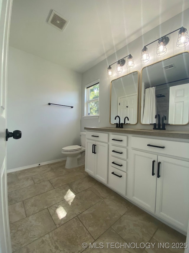 bathroom with toilet, a shower with shower curtain, a sink, visible vents, and double vanity