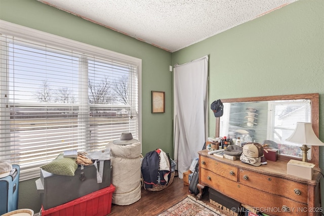 bedroom featuring a textured ceiling and wood finished floors