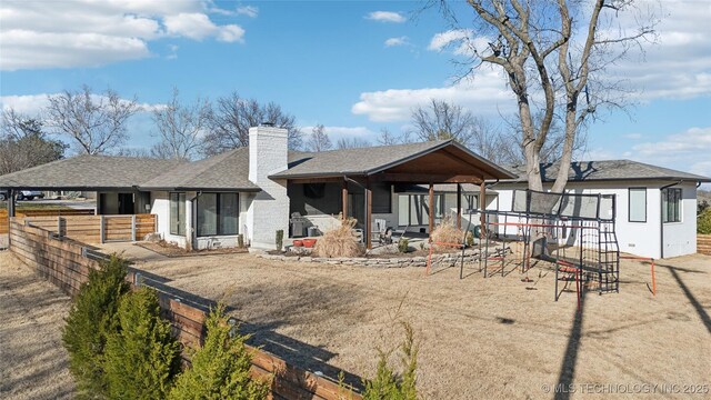 2808 E 37th Pl, Tulsa, OK 74105 - rear view of house with a chimney and roof with shingles