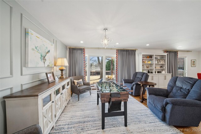 2808 E 37th Pl, Tulsa, OK 74105 - living area featuring a chandelier, recessed lighting, and light wood-style flooring