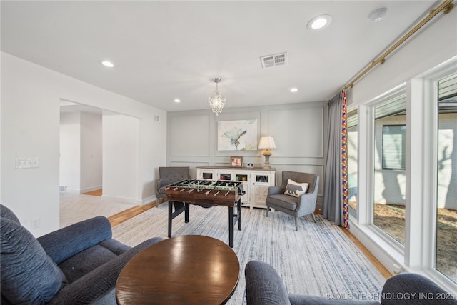 2808 E 37th Pl, Tulsa, OK 74105 - living area with healthy amount of natural light, light wood-style floors, recessed lighting, a chandelier, and a decorative wall