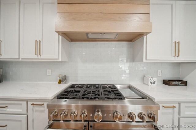 2808 E 37th Pl, Tulsa, OK 74105 - kitchen with stainless steel range with gas cooktop, custom exhaust hood, and white cabinetry