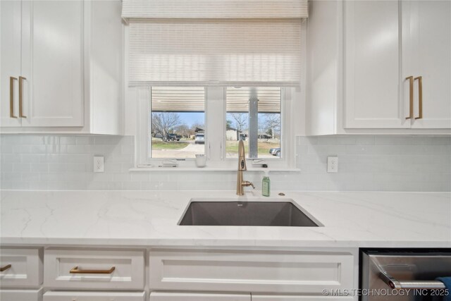 2808 E 37th Pl, Tulsa, OK 74105 - kitchen with white cabinets, decorative backsplash, and stainless steel dishwasher