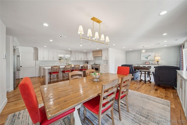 2808 E 37th Pl, Tulsa, OK 74105 - dining area with light wood-style flooring, recessed lighting, and a chandelier