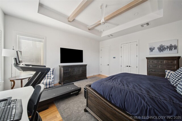2808 E 37th Pl, Tulsa, OK 74105 - bedroom featuring wood finished floors, beamed ceiling, a ceiling fan, and a desk