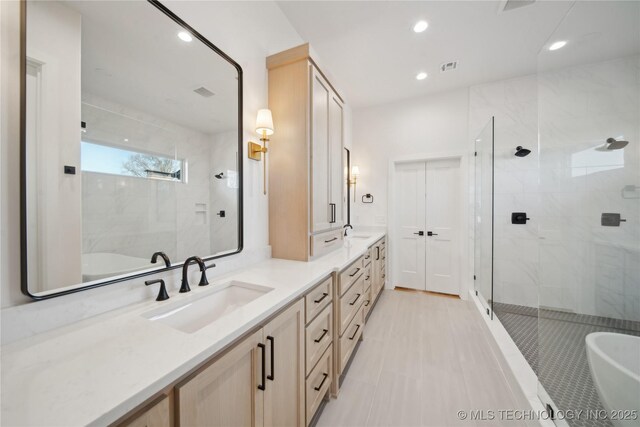 2808 E 37th Pl, Tulsa, OK 74105 - bathroom with double vanity, a freestanding bath, a stall shower, and recessed lighting