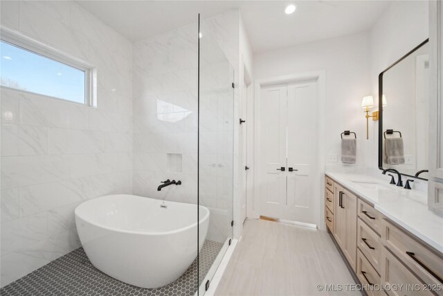 2808 E 37th Pl, Tulsa, OK 74105 - bathroom with vanity, a freestanding tub, tile walls, tile patterned flooring, and recessed lighting