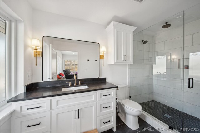 2808 E 37th Pl, Tulsa, OK 74105 - full bathroom with a shower stall, vanity, tile patterned floors, and ensuite bath