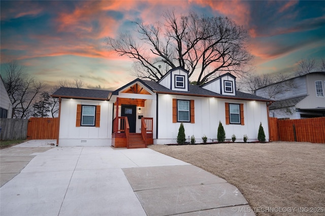 modern farmhouse featuring board and batten siding, crawl space, roof with shingles, and fence