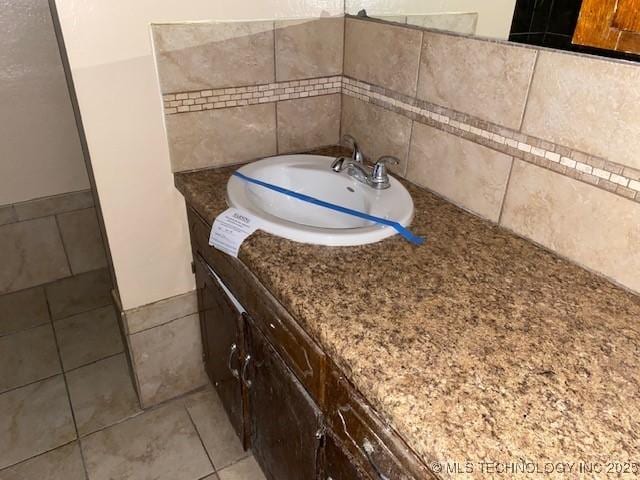 bathroom with tile patterned flooring and vanity