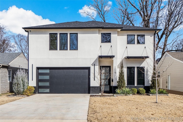 view of front of property featuring a garage, driveway, and stucco siding