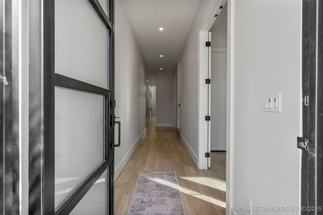 corridor with recessed lighting, light wood-style flooring, and baseboards