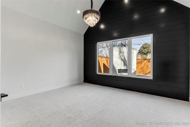 home theater featuring carpet floors, lofted ceiling, a notable chandelier, and baseboards