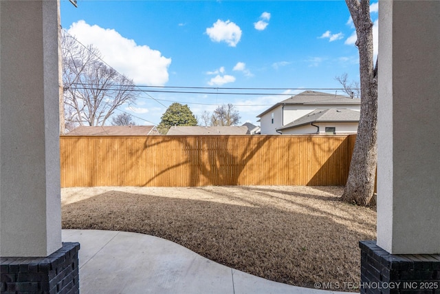 view of yard featuring a patio and fence