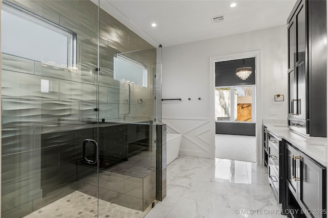 full bath featuring a stall shower, visible vents, a soaking tub, marble finish floor, and a decorative wall