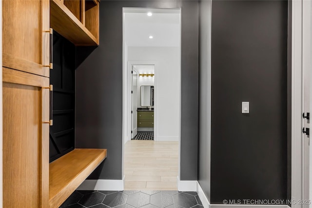 mudroom with tile patterned flooring and baseboards