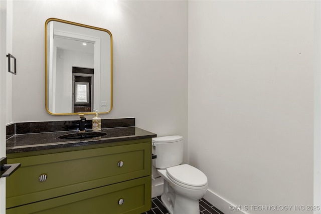 bathroom featuring tile patterned flooring, vanity, and toilet