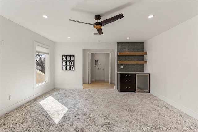 unfurnished living room featuring baseboards, visible vents, a ceiling fan, light colored carpet, and recessed lighting