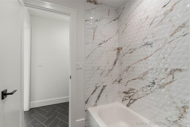 full bathroom featuring baseboards