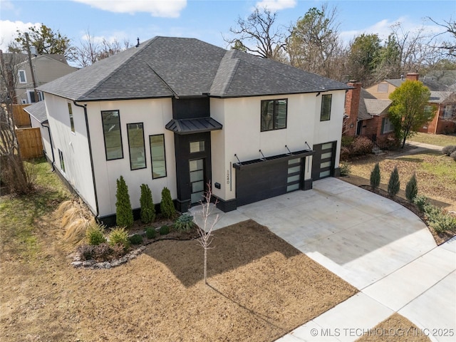 view of front of home featuring a standing seam roof, metal roof, concrete driveway, and roof with shingles