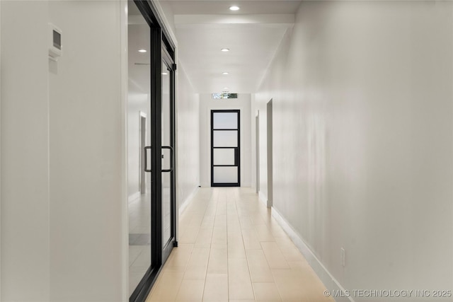 corridor with recessed lighting and baseboards