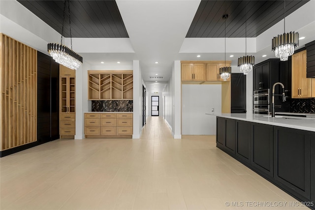 kitchen with tasteful backsplash, a raised ceiling, light countertops, double oven, and recessed lighting