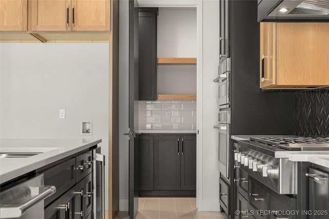 kitchen with stainless steel appliances, wall chimney range hood, decorative backsplash, light stone countertops, and open shelves