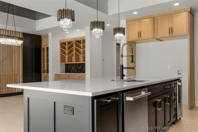 kitchen featuring pendant lighting, recessed lighting, decorative backsplash, a sink, and an island with sink