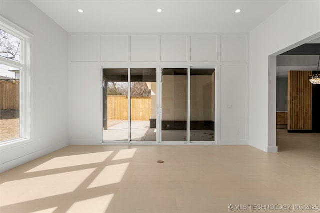 unfurnished room with a wealth of natural light and recessed lighting