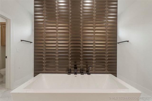 bathroom with a bathing tub and toilet