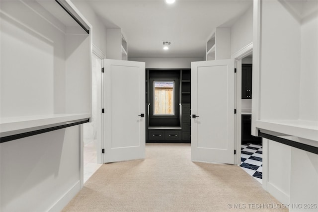 spacious closet featuring visible vents