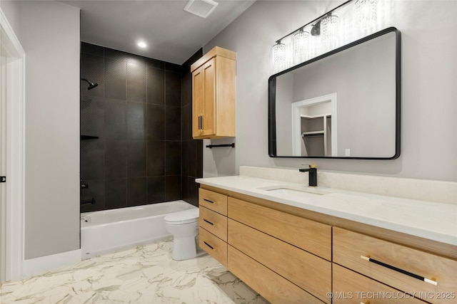 full bath with toilet, vanity, visible vents, marble finish floor, and washtub / shower combination