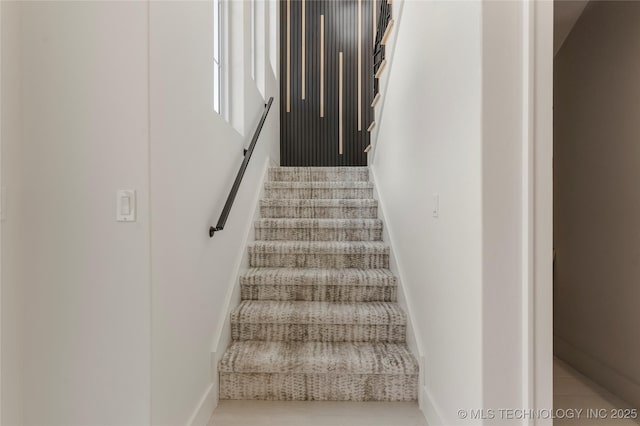 staircase featuring baseboards