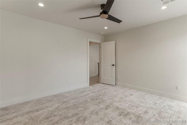 carpeted empty room featuring baseboards, a ceiling fan, and recessed lighting