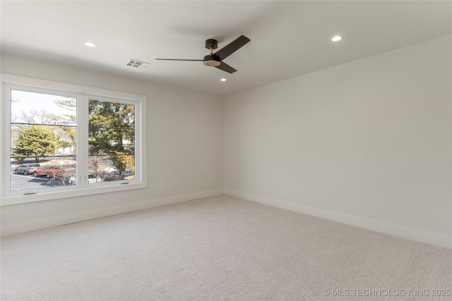 carpeted empty room featuring baseboards, a ceiling fan, visible vents, and recessed lighting