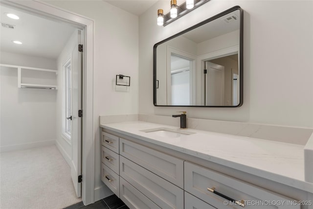 bathroom with recessed lighting, visible vents, baseboards, and vanity