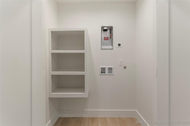 laundry area with laundry area, washer hookup, baseboards, wood tiled floor, and electric dryer hookup