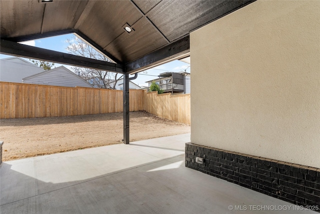 view of patio / terrace featuring fence