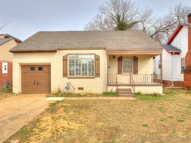 view of front of property featuring a garage, roof with shingles, crawl space, a porch, and brick siding