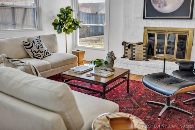 living room with a fireplace and wood finished floors