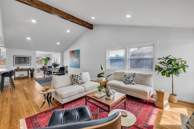 living area with recessed lighting, lofted ceiling with beams, baseboards, and wood finished floors