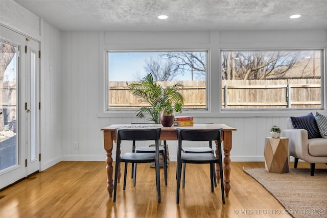 dining space featuring a wealth of natural light, baseboards, and wood finished floors