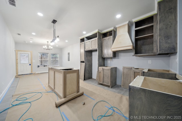 kitchen featuring premium range hood, visible vents, a center island, recessed lighting, and baseboards