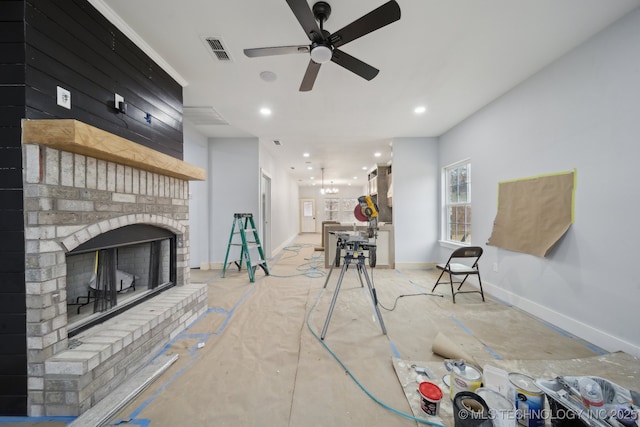 living area with recessed lighting, visible vents, baseboards, and a brick fireplace