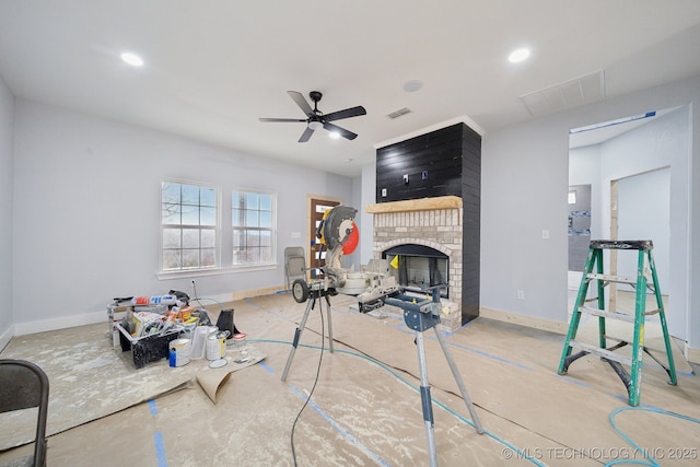 interior space featuring a brick fireplace, baseboards, and visible vents